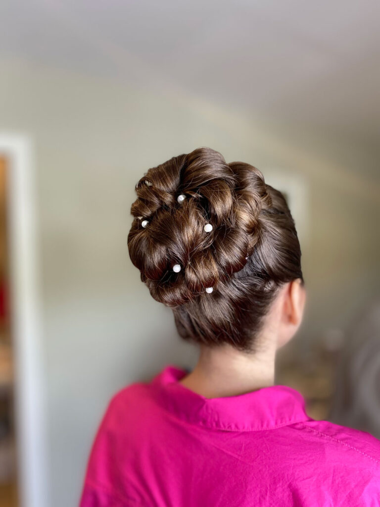 Bride sitting in chair during wedding hair and makeup trial