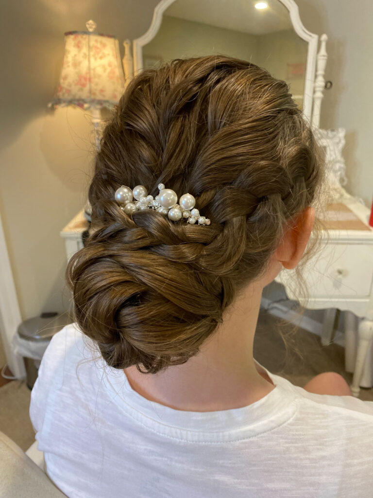 Bride sitting in chair during wedding hair and makeup trial