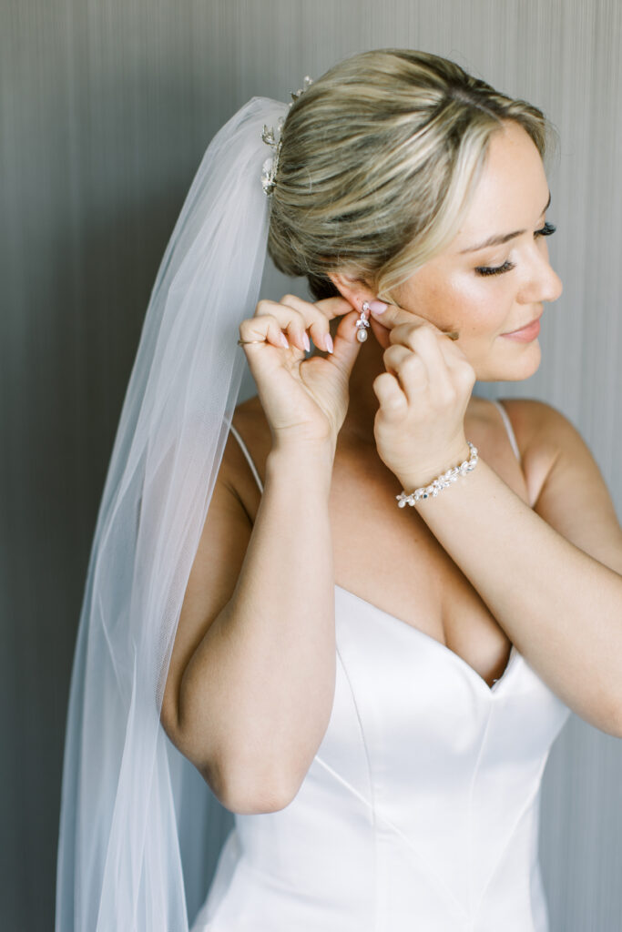 Bride and groom sharing a romantic kiss outdoors after their Fairfield County wedding, featuring flawless hair and makeup by A Touch of Color.